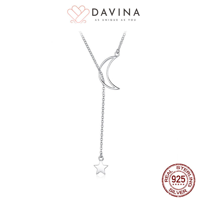 A sterling silver necklace with a crescent moon and star pendant